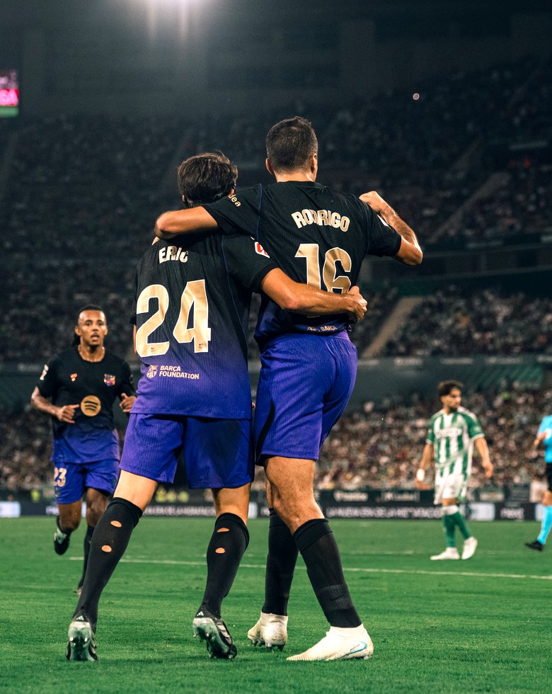 Barcelona players celebrate under the floodlights